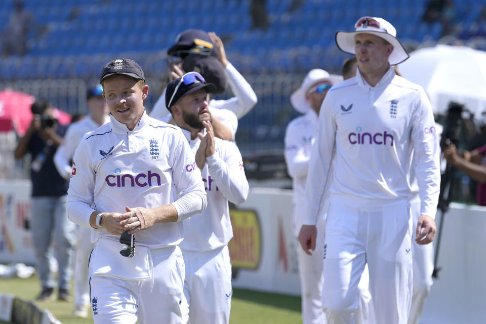 England's Ollie Pope, left, and teammates walk off the field after winning the first test cricket match against Pakistan, in Multan, Pakistan, Friday, Oct. 11, 2024. (AP Photo/Anjum Naveed)