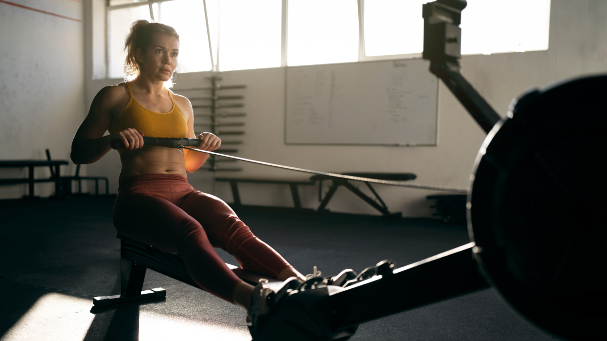  Woman doing a rowing machine workout. 