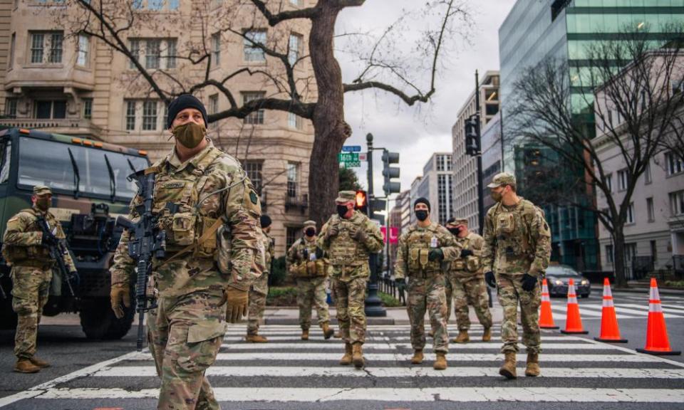 National guard troops walk the streets in Washington DC on 17 January.