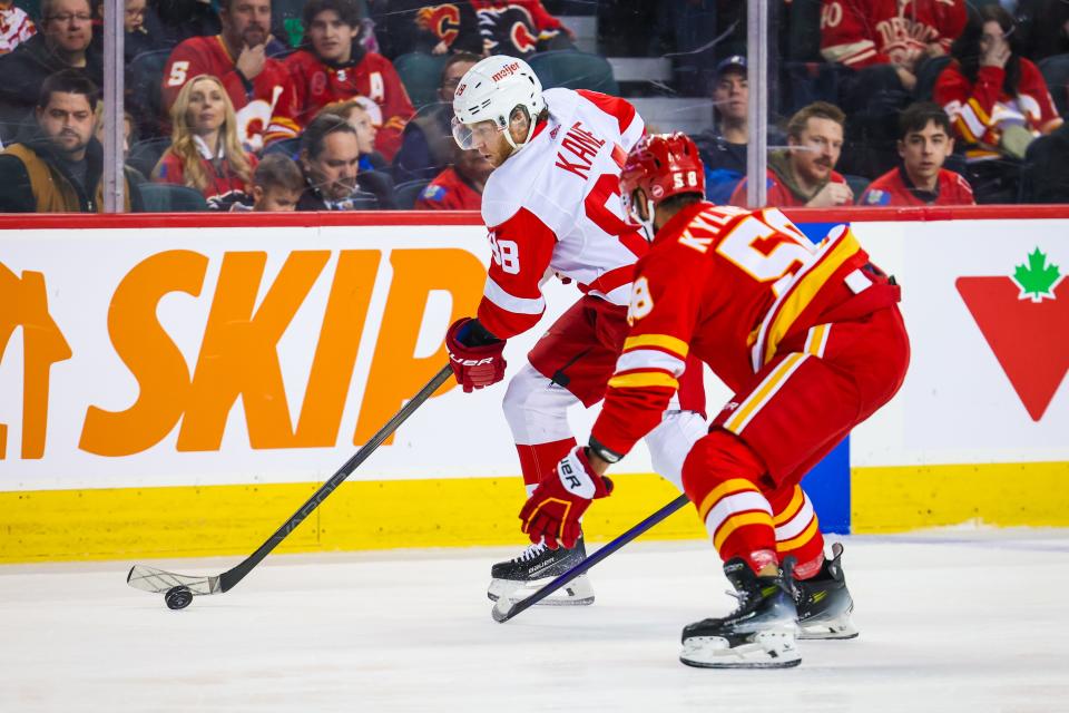 Detroit Red Wings right wing Patrick Kane (88) controls the puck against Calgary Flames defenseman Oliver Kylington (58) during the first period at Scotiabank Saddledome in Calgary, Alberta, on Saturday, Feb. 17, 2024.