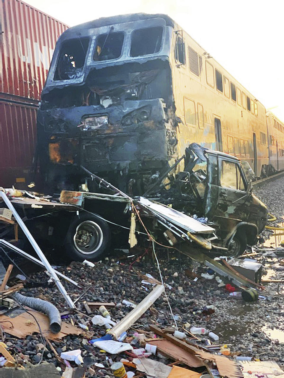 This photo provided by the Norwalk Sheriff's Station shows first responders at the scene after an RV was hit by a commuter train and burst into flames along a track in Santa Fe Springs, Calif., Friday, Nov. 22, 2019. Authorities say the collision occurred shortly after 5:30 a.m. Friday at an intersection in an industrial area of Santa Fe Springs. There were no immediate reports of injuries. All passengers on the Metrolink train were safely evacuated. (Norwalk Sheriff's Station via AP)