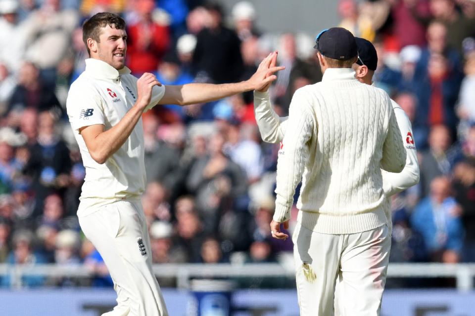 England's Craig Overton (L) celebrates with teammates after taking the wicket of Australia's captain Tim Paine during play on the second day of the fourth Ashes cricket Test match between England and Australia at Old Trafford in Manchester, north-west England on September 5, 2019. (Photo by Paul ELLIS / AFP) / RESTRICTED TO EDITORIAL USE. NO ASSOCIATION WITH DIRECT COMPETITOR OF SPONSOR, PARTNER, OR SUPPLIER OF THE ECB        (Photo credit should read PAUL ELLIS/AFP/Getty Images)