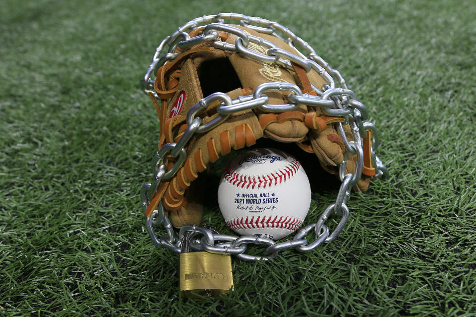 Atlanta, GA - January 09:  An Official Rawlings Major League baseball sits with a glove, lock and chain to represent the lockout between Major League Baseball (MLB) and the Major League Baseball Players Association (MLBPA) on January 09, 2022 in Atlanta, Georgia.   (Photo by David J. Griffin/Icon Sportswire via Getty Images)