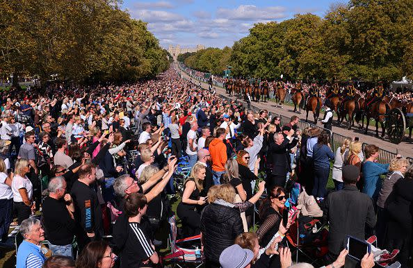 WINDSOR, ENGLAND - SEPTEMBER 19: Members of the public line the Long Walk on September 19, 2022 in Windsor, England. The committal service at St George's Chapel, Windsor Castle, took place following the state funeral at Westminster Abbey. A private burial in The King George VI Memorial Chapel followed. Queen Elizabeth II died at Balmoral Castle in Scotland on September 8, 2022, and is succeeded by her eldest son, King Charles III. (Photo by Richard Heathcote/Getty Images)