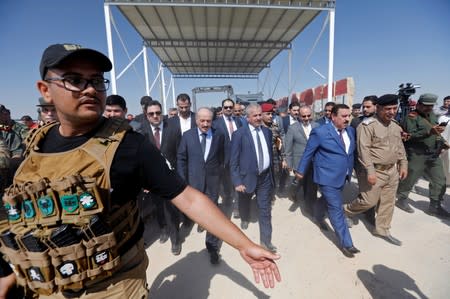 Syrian Interior Minister Mohammad Khaled al-Rahmoun walks at the Iraqi-Syrian border