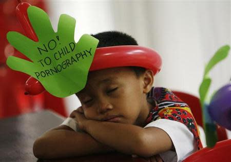 A boy takes a break during a forum against child pornography at the multi-purpose hall of the Caritas in Manila June 5, 2009. REUTERS/Romeo Ranoco/Files