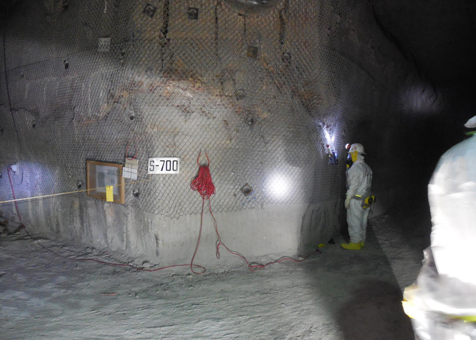 This April 2, 2014, image provided by the U.S. Department of Energy shows workers underground inside the Waste Isolation Pilot Plant facility in Carlsbad, N.M., for the first time since the Feb. 14 radiological release. The operators of this federal government's troubled nuclear waste dump are bracing for a scathing report Wednesday, April 23, 2014, on their response to a radiation release that contaminated 21 workers and shuttered the southeastern New Mexico facility two months ago. (AP Photo/U.S. Department of Energy)