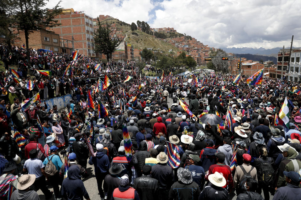 Anti-government demonstrators accompany the remains of people killed in clashes between supporters of former President Evo Morales and security forces, in a funeral procession into La Paz, Bolivia, Thursday, Nov. 21, 2019. At least eight people were killed Tuesday when security forces cleared a blockade of a fuel plant by supporters of former President Evo Morales at protesters in the city of El Alto. (AP Photo/Natacha Pisarenko)