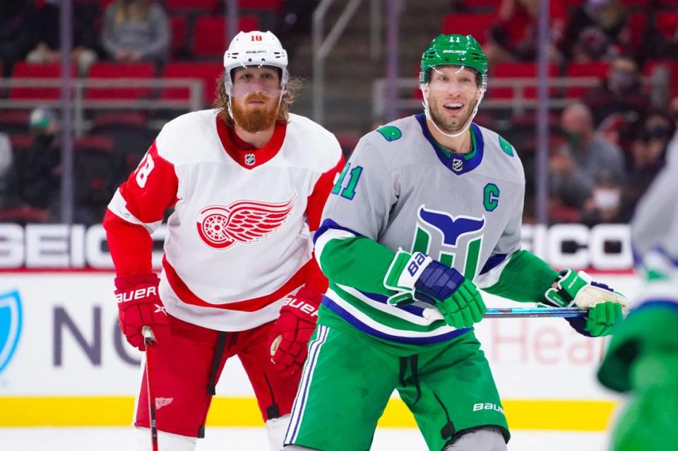 Apr 10, 2021; Raleigh, North Carolina, USA; Carolina Hurricanes center Jordan Staal (11) and Detroit Red Wings defenseman Marc Staal (18) look on during a game at PNC Arena.