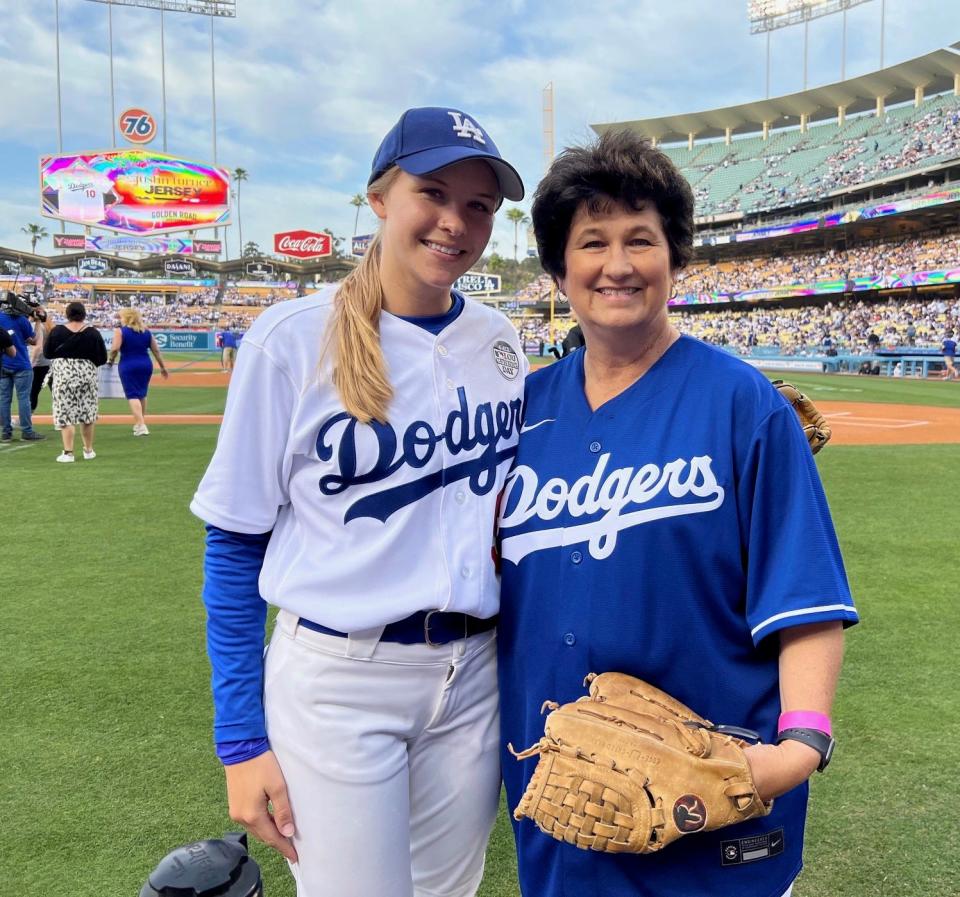 Palm Springs resident Denise Goolsby poses with Dodgers ball girl Marissa Rohan who caught Goolsby's ceremonial first pitch at Dodger Stadium on Thursday.