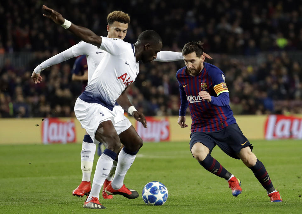Barcelona forward Lionel Messi, right, vies for the ball with Tottenham midfielder Moussa Sissoko during the Champions League group B soccer match between FC Barcelona and Tottenham Hotspur at the Camp Nou stadium in Barcelona, Spain, Tuesday, Dec. 11, 2018. (AP Photo/Emilio Morenatti)