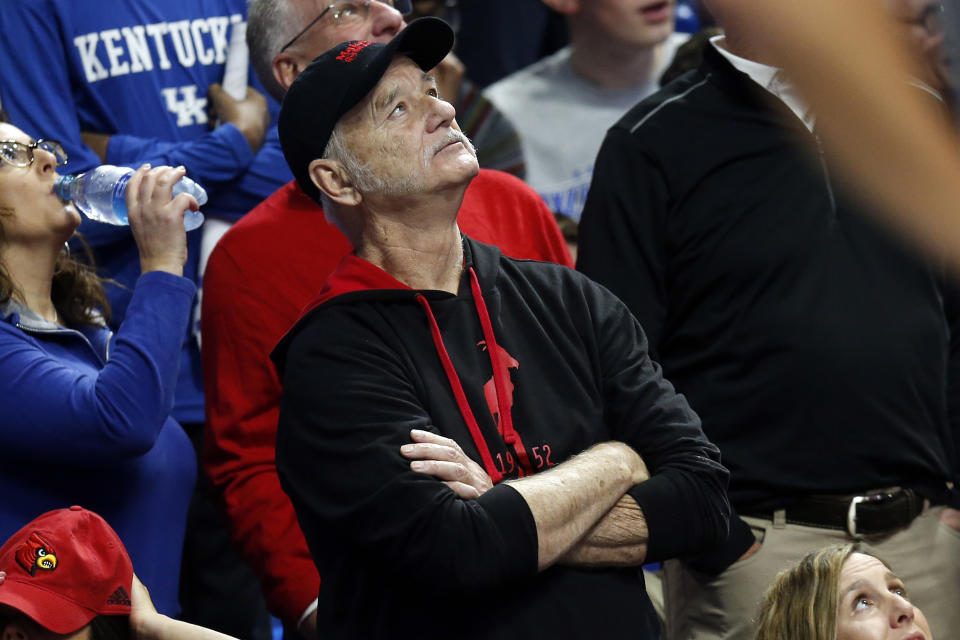 Bill Murray looks at the scoreboard during the first half of an NCAA college basketball game between Kentucky and Louisville in Lexington, Ky., Saturday, Dec. 28, 2019. Murray's son is an assistant in Louisvile. (AP Photo/James Crisp)