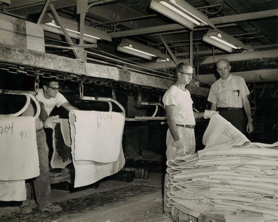 Rubber workers at Goodyear Tire &amp; Rubber Co. handle uncured raw rubber that was milled in the industrial products department and dusted with talc or soapstone to prevent the uncured rubber from sticking to machinery or other slabs of rubber. The slabs were then used to make products like mats, hoses and conveyor belts.