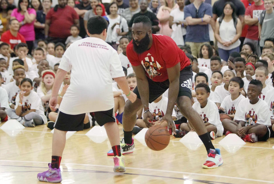 James Harden plays with a kid during the James Harden Basketball Camp (Photo by Song Qiong/Xinhua via Getty) (Xinhua/Liu Liwei via Getty Images)