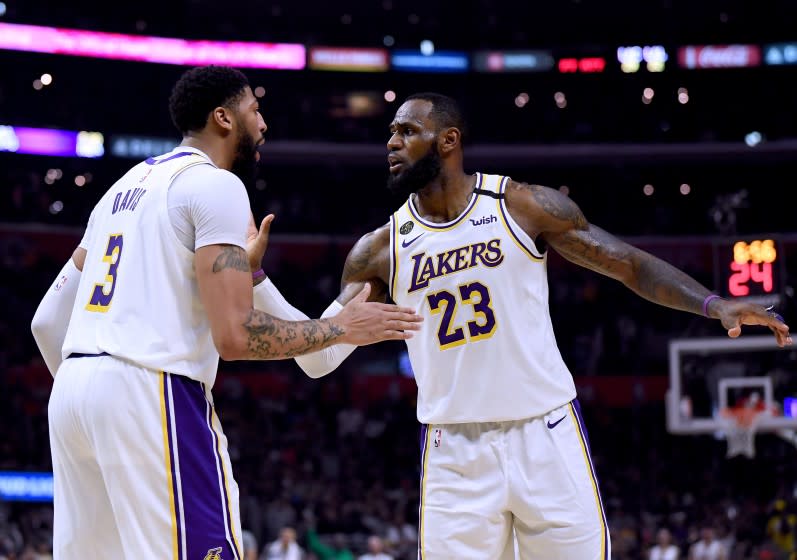 LOS ANGELES, CALIFORNIA - MARCH 08: LeBron James #23 and Anthony Davis #3 of the Los Angeles Lakers celebrate a basket during a 112-103 win over the LA Clippers at Staples Center on March 08, 2020 in Los Angeles, California. NOTE TO USER: User expressly acknowledges and agrees that, by downloading and or using this photograph, User is consenting to the terms and conditions of the Getty Images License Agreement. (Photo by Harry How/Getty Images)