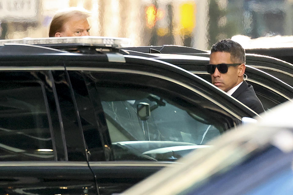 Former President Donald Trump, left, departs Trump Tower to attend a pre-trial hearing in Manhattan criminal court, Monday, March 25, 2024, in New York. A judge will weigh on Monday when the former president will go on trial. (AP Photo/Yuki Iwamura)