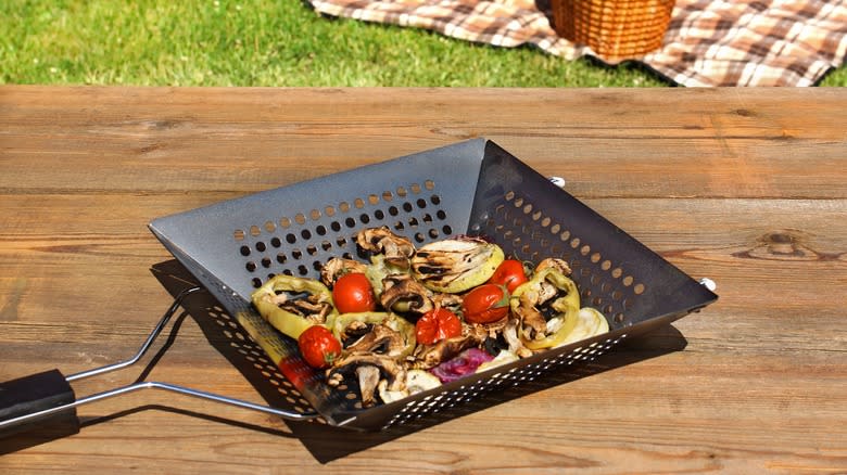 vegetables in grill basked on picnic table