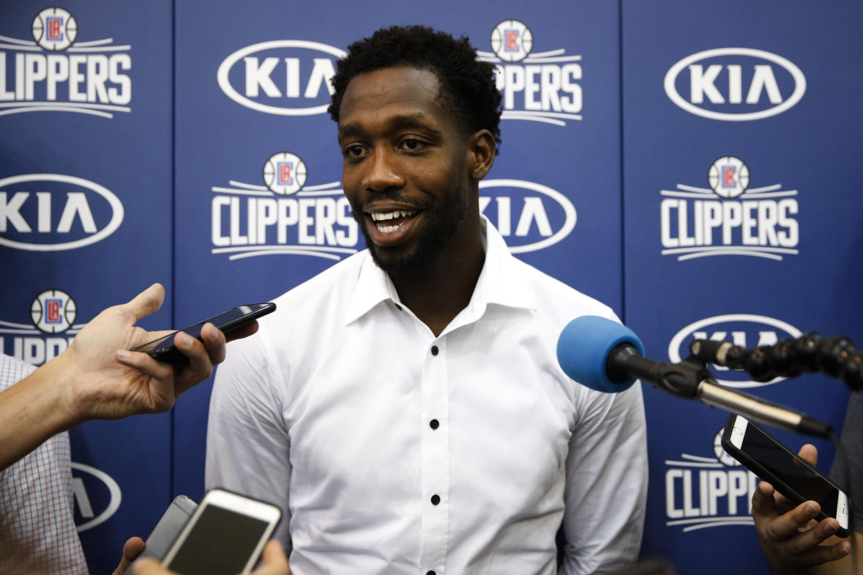 Patrick Beverley gets comfortable in front of the microphone. (AP)