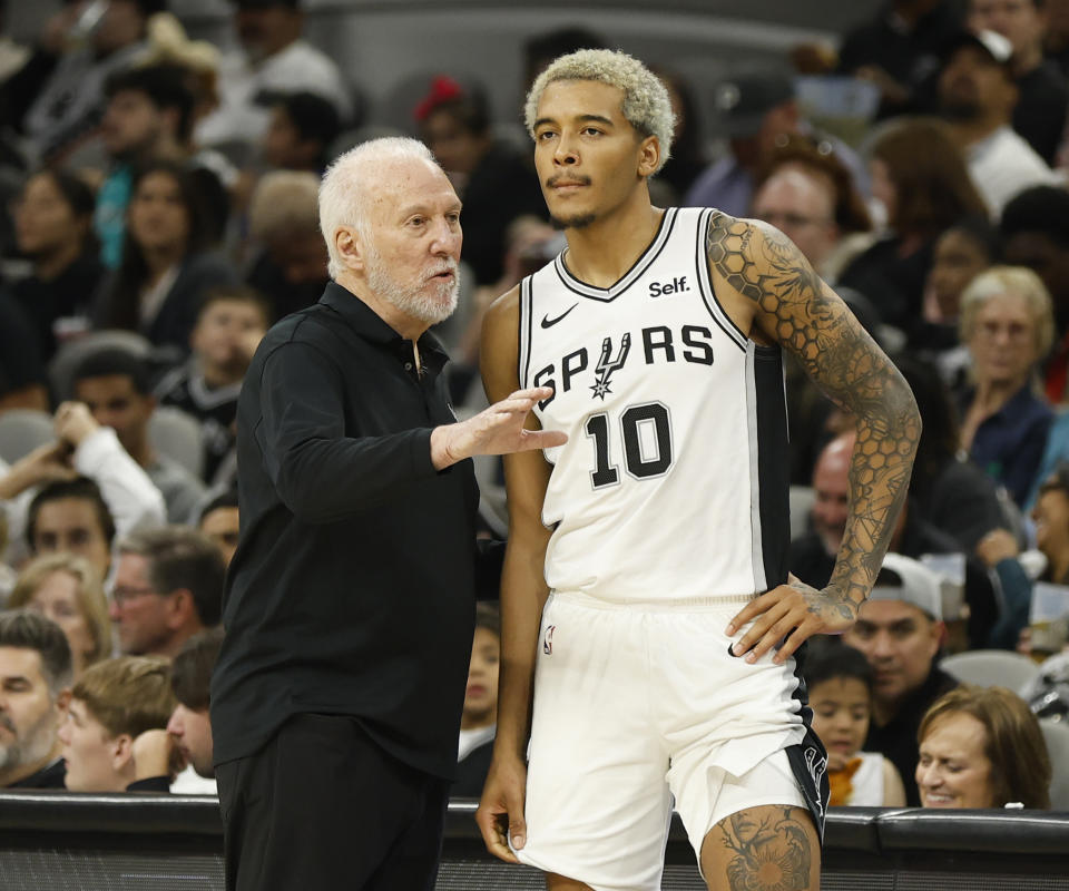 SAN ANTONIO, TX - OCTOBER 16: Jeremy Sochan #10 of the San Antonio Spurs listen to head coach Gregg Popovich during second half action against the Houston Rockets in a pre-season NBA game at Frost Bank Center on October 16, 2023 in San Antonio, Texas. NOTE TO USER: User expressly acknowledges and agrees that, by downloading and or using this photograph, User is consenting to terms and conditions of the Getty Images License Agreement. (Photo by Ronald Cortes/Getty Images)