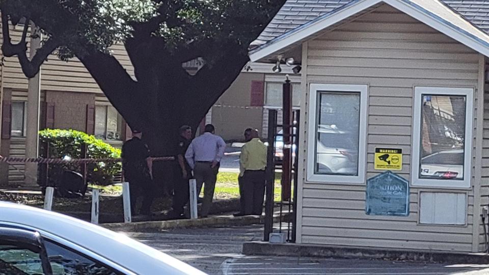 Sheriff's Office investigators confer at the scene of Friday's triple shooting at the River City Landing apartment complex on University Boulevard across from Jacksonville University.