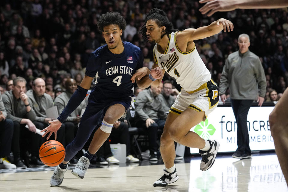 Penn State forward Puff Johnson (4) drives on Purdue forward Trey Kaufman-Renn (4) during the first half of an NCAA college basketball game in West Lafayette, Ind., Saturday, Jan. 13, 2024. (AP Photo/Michael Conroy)