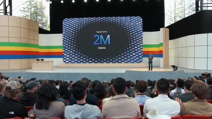 Google I/O stage with a slide on the screen talking about Gemini.