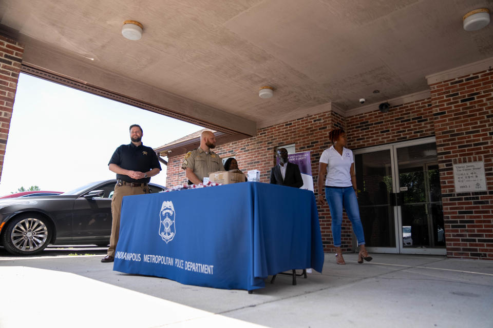 Officers and members of the church hand out gun locks to residents Sunday, July 2, 2023, at New Liberty Missionary Baptist Church in Indianapolis.