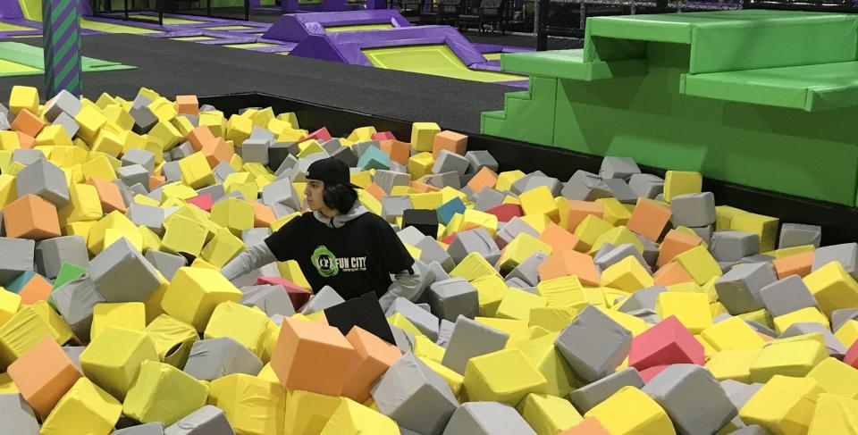 Fun City Adventure Park employee Chase Calvano, a B-P sophomore, prepares cushions inside a trampoline for jumpers on Jan. 10, 2023.