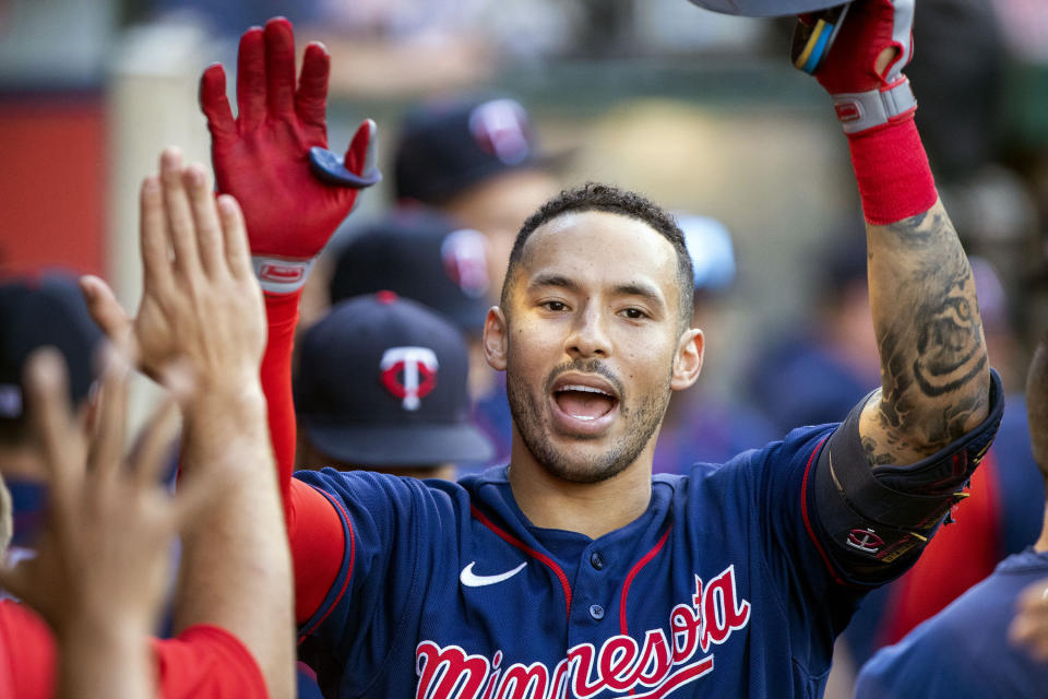 FILE - Minnesota Twins' Carlos Correa, right, is congratulated after hitting a solo home run against the Los Angeles Angels during the first inning of a baseball game in Anaheim, Calif., Saturday, Aug. 13, 2022. In a wild twist overnight, Carlos Correa agreed to a $315 million, 12-year contract with the free-spending New York Mets after his pending deal with the San Francisco Giants came apart over an issue with his physical. (AP Photo/Alex Gallardo, File)