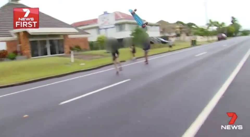 One of the teens throws his skateboard at the cameraman, who keeps filming. Source: 7 News