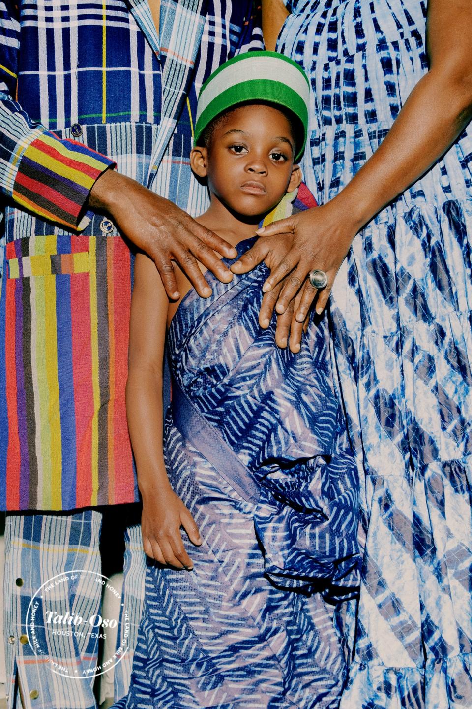 Jaye Talib-Oso and Toyin Talib-Oso with their youngest son, Tolu, all wearing Amao.