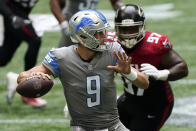 Detroit Lions quarterback Matthew Stafford (9) works in the pocket under pressure by Atlanta Falcons defensive tackle Grady Jarrett (97) during the first half of an NFL football game, Sunday, Oct. 25, 2020, in Atlanta. (AP Photo/John Bazemore)