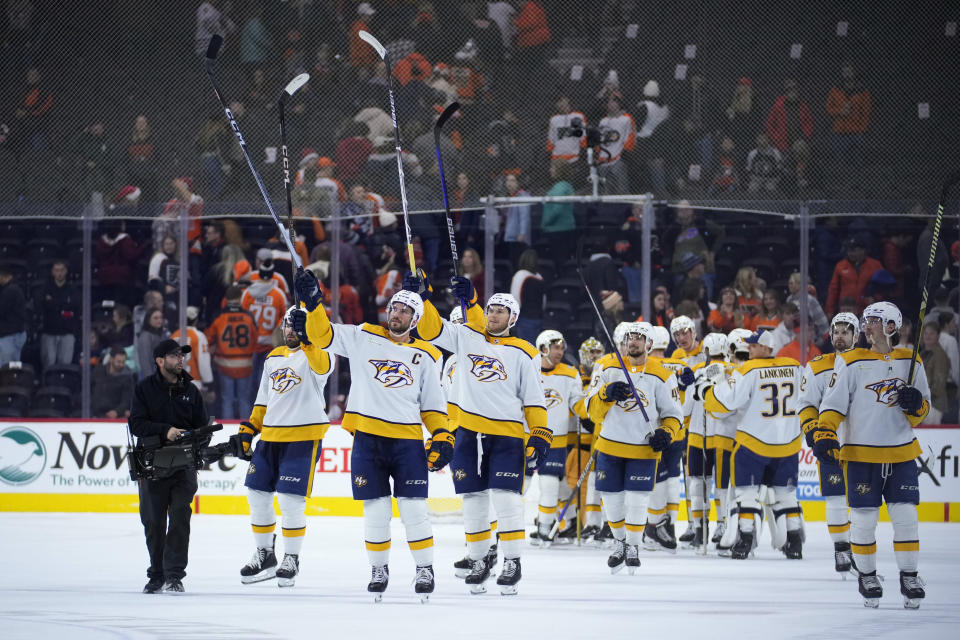 Nashville Predators' players react after winning an NHL hockey game against the Philadelphia Flyers, Thursday, Dec. 21, 2023, in Philadelphia. (AP Photo/Matt Slocum)