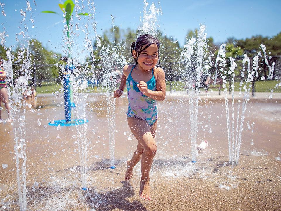 Adalea Juarez, 4, of Galesburg giggles as she runs through a sprinkler at the Rotary Park Splashpad on Friday, June 4, 2021. While city wading pools and splashpads have opened for the summer, a sign at Lakeside Recreation Facility informs visitors that the pool will tentatively open on Tuesday, June 8.