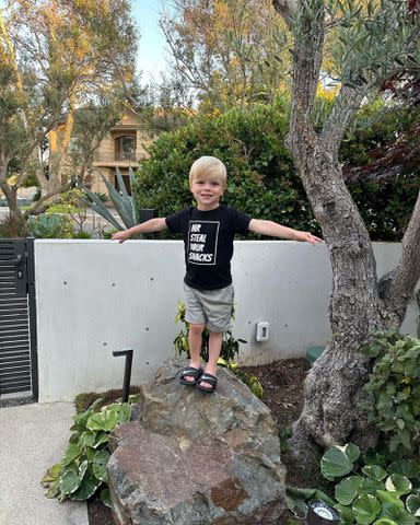 <p>Christina Hall Instagram</p> Christina Hall's son Hudson Anstead stands on a rock