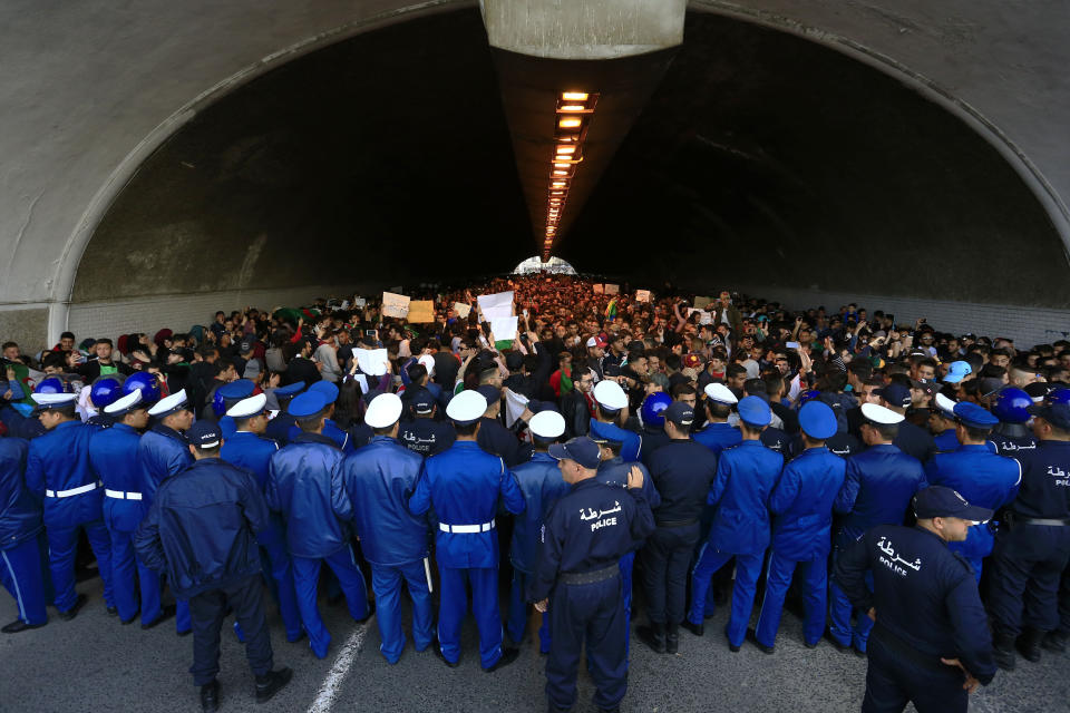 Algerian police forces block a tunnel where hundreds of students gather in central Algiers to protest Algerian President Abdelaziz Bouteflika's decision to seek fifth term, Tuesday, March 6, 2019. Algerian students are gathering for new protests and are calling for a general strike if he doesn't meet their demands this week. (AP Photo/Toufik Doudou)