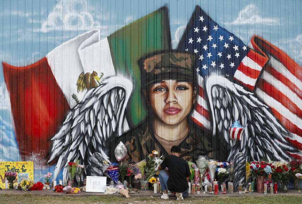 Juan Cruz, boyfriend of Army soldier Vanessa Guillén, kneels in front of a mural honoring her Sunday, July 5, 2020, in Houston. Army investigators have identified the body of a soldier who vanished more than two months ago from a base in Texas, according to a lawyer for the soldier's family. Remains found last week buried near Fort Hood belong to Guillén and Army officials informed her family in Houston Sunday, attorney Natalie Khawam told The Associated Press. (Godofredo A. Vásquez/Houston Chronicle via AP)