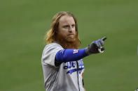 Los Angeles Dodgers' Justin Turner points towards the San Diego Padres dugout after getting hit by a pitch from San Diego Padres starting pitcher Dinelson Lamet during the sixth inning of a baseball game Tuesday, Aug. 4, 2020, in San Diego. (AP Photo/Gregory Bull)