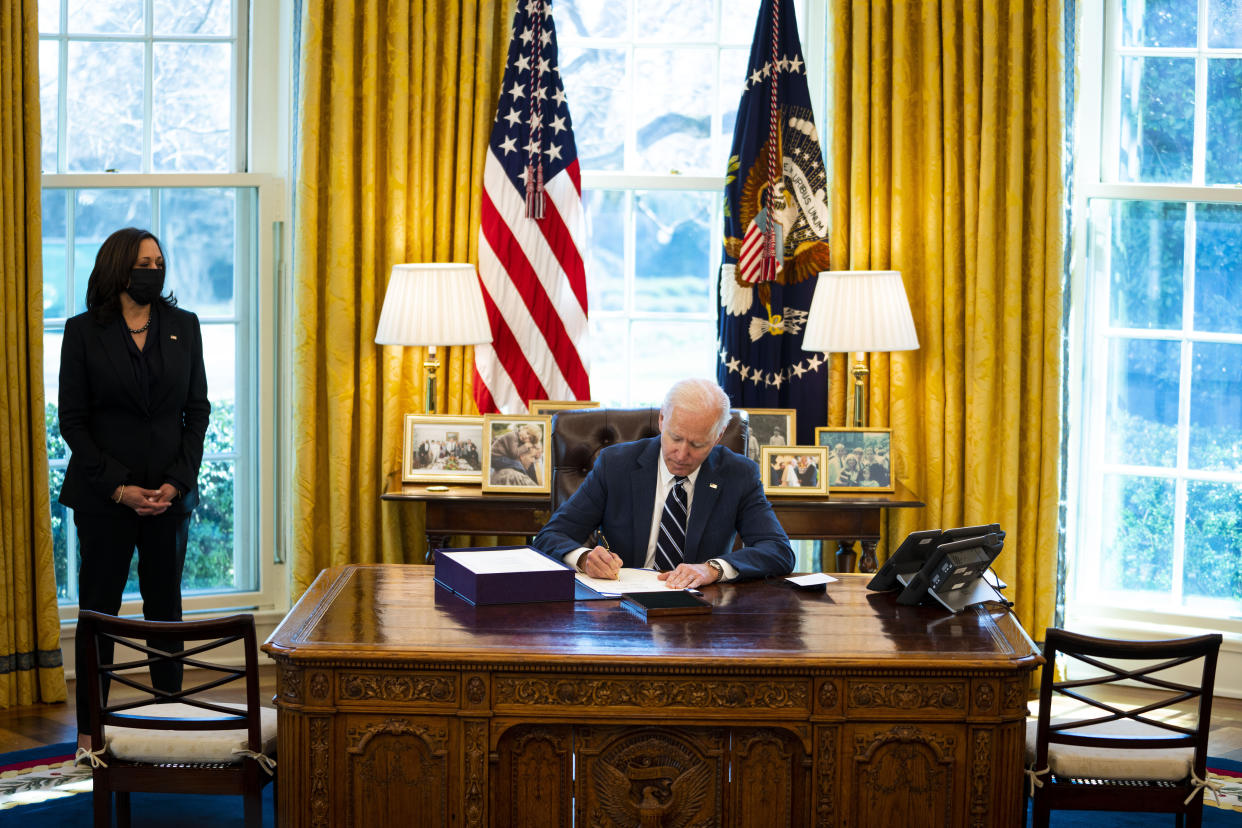 WASHINGTON, DC - MARCH 11: U.S. President Joe Biden participates in a bill signing as Vice President Kamala Harris looks on in the Oval Office of the White House on March 11, 2021 in Washington, DC. President Biden has signed the $1.9 trillion COVID relief bill into law at the event. (Photo by Doug Mills-Pool/Getty Images)