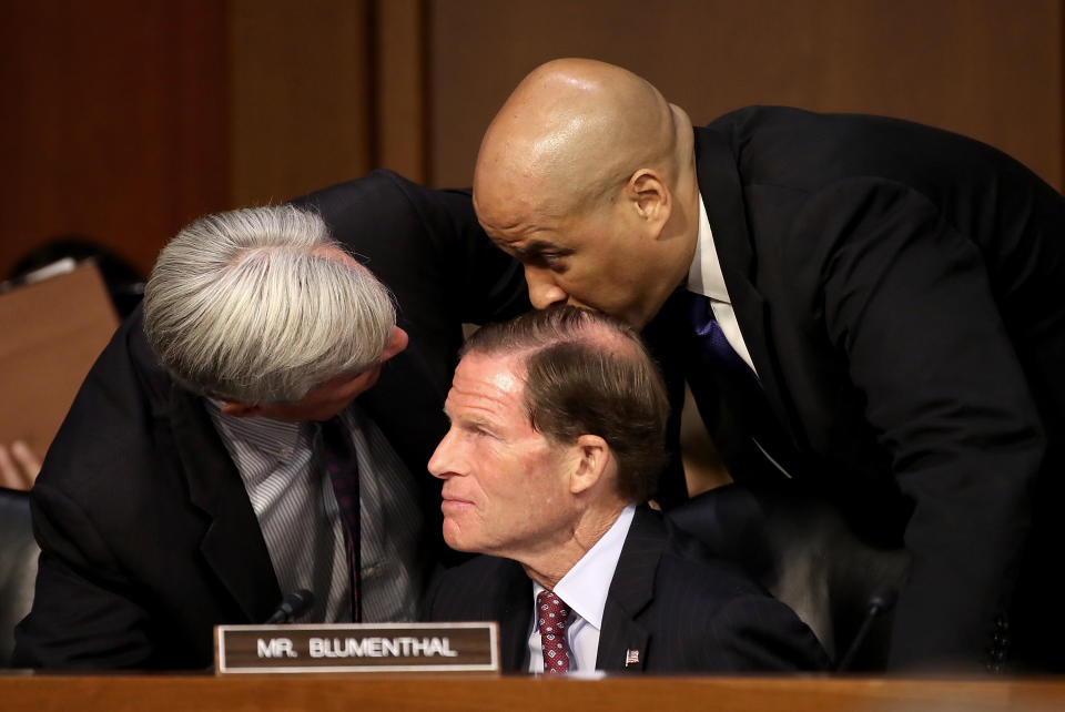Left to right: Sens. Sheldon Whitehouse, D-R.I., Richard Blumenthal, D-Conn. and Cory Booker, D-N.J. huddle as Supreme Court nominee Judge Brett Kavanaugh appears for his confirmation hearing before the Senate Judiciary Committee in the Hart Senate Office Building on Capitol Hill Tuesday in Washington, D.C. (Photo: Mark Wilson/Getty Images)