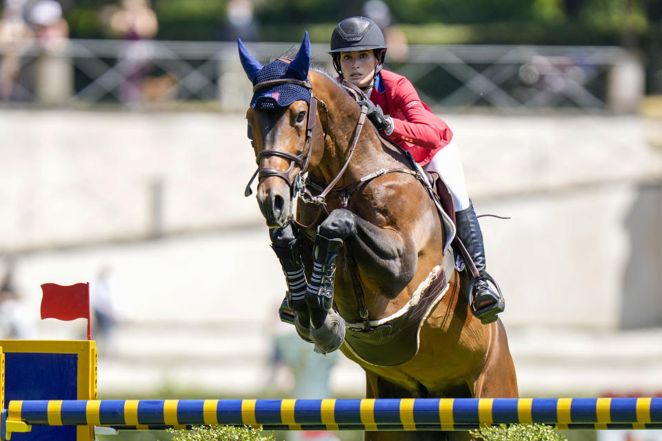 FILE - Jessica Springsteen on Don Juan Van de Donkhoeve, clears an obstacle during the Nations Cup horse jumping competition in Rome, in this Friday, May 28, 2021, file photo. The daughter of rock icon Bruce Springsteen and singer-songwriter Patti Scialfa has been selected as one of four riders on the U.S. jumping team that will compete at the Tokyo Olympics. Twenty-nine-year-old Jessica Springsteen is making her Olympic debut.(AP Photo/Andrew Medichini, File)