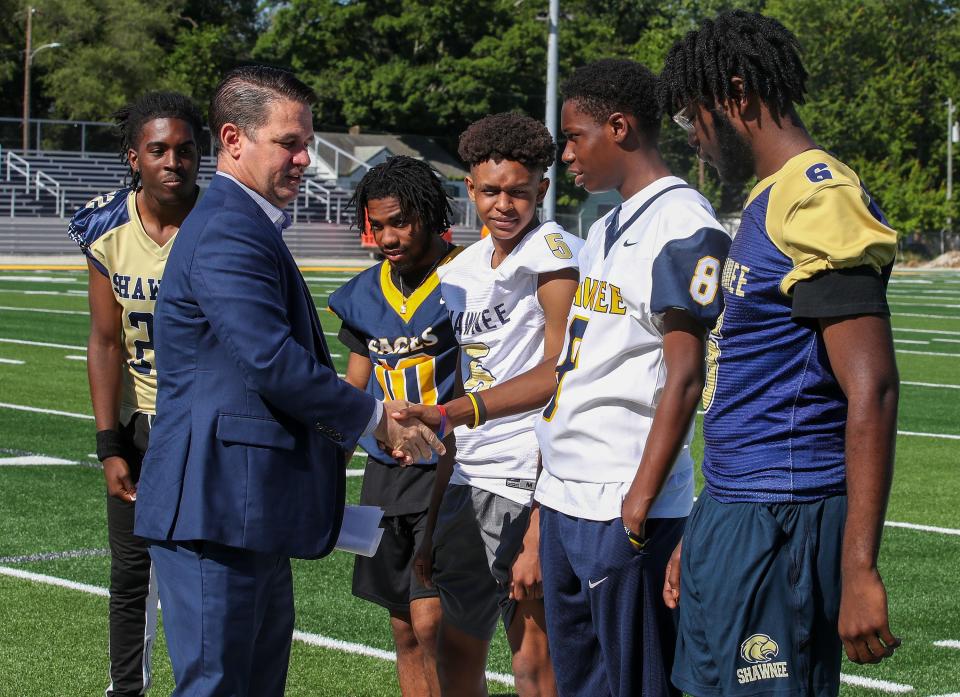 JCPS Superintendent Marty Pollio meets members of the Academy @ Shawnee football team during the unveiling of the new field and grandstands