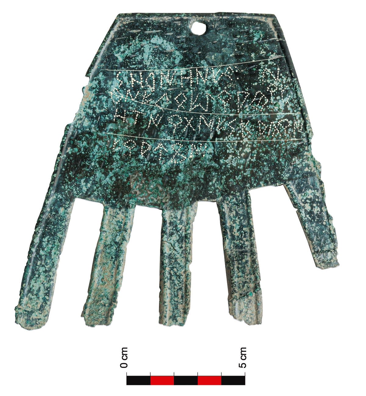 The 2100 year old sheet bronze ‘severed hand’ symbol, with its inscription probably referring to a ‘good fortune’ deity (Aranzadi Science Society)