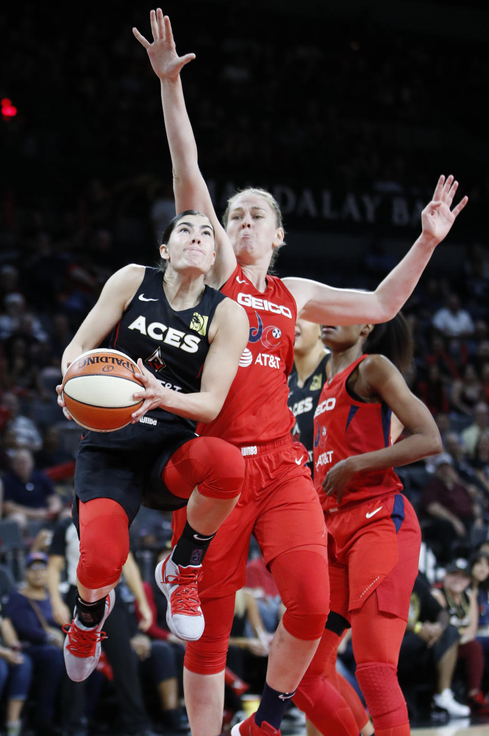 Las Vegas Aces' Kelsey Plum shoots around Washington Mystics' Emma Meesseman during the first half of Game 4 of a WNBA playoff basketball series Tuesday, Sept. 24, 2019, in Las Vegas. (AP Photo/John Locher)