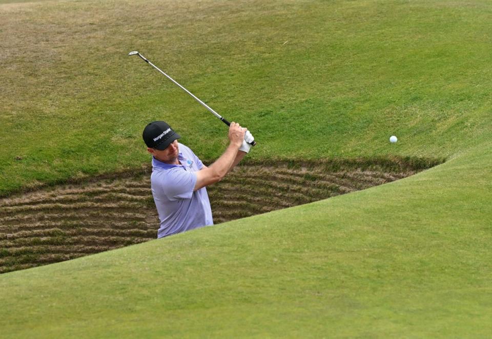 Justin Rose plays out of the road hole bunker (AFP via Getty Images)