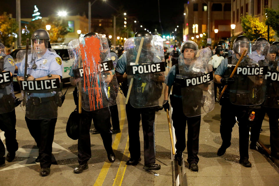 <p>Police officers watch as people march the day after the not guilty verdict in the murder trial of Jason Stockley, a former St. Louis police officer, charged with the 2011 shooting of Anthony Lamar Smith, who was black, in St. Louis, Mo., Sept. 16, 2017. (Photo: Joshua Lott/Reuters) </p>