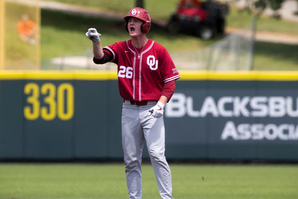 Oklahoma's Blake Robertson (26) reacts after a hit against Virginia Tech in the fifth inning of an NCAA college baseball super regional game Sunday, June 12, 2022, in Blacksburg, Va. (AP Photo/Scott P. Yates)
