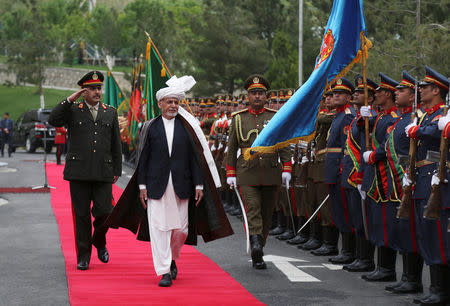 Afghan President Ashraf Ghani inspects an honor guard during the first day of the Loya Jirga, or the consultative council, in Kabul, Afghanistan, April 29, 2019. Rahmat Gul/Pool via REUTERS