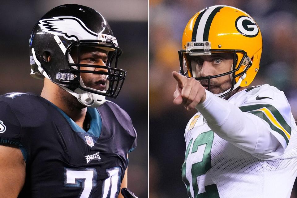 Ndamukong Suh #74 of the Philadelphia Eagles looks on prior to the game against the Green Bay Packers at Lincoln Financial Field on November 27, 2022 in Philadelphia, Pennsylvania. (Photo by Mitchell Leff/Getty Images); Aaron Rodgers #12 of the Green Bay Packers points against the Philadelphia Eagles at Lincoln Financial Field on November 27, 2022 in Philadelphia, Pennsylvania. (Photo by Mitchell Leff/Getty Images)