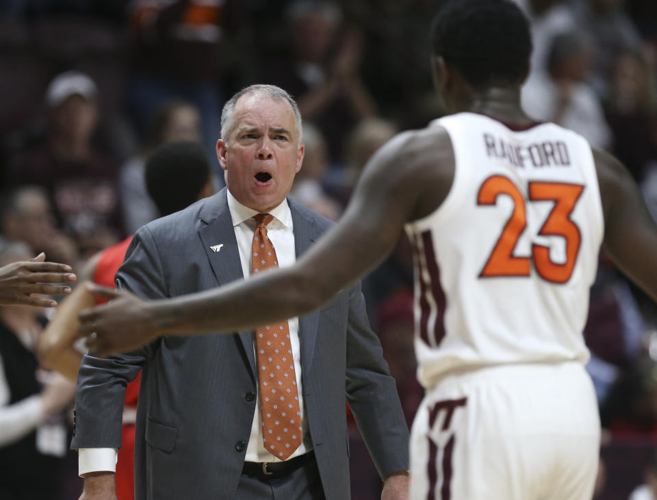 Virginia Tech head coach Mike Young, left, greets Tyrece Radford (23) after an offensive series in the first half of an NCAA college basketball game against Virginia Military Institute, Saturday, Dec. 21 2019, in Blacksburg, Va. (Matt Gentry/The Roanoke Times via AP)